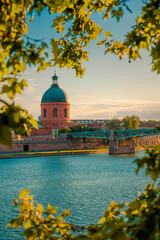 toulouse, france. beautiful cityscape with the river garonne and la grave dome in the background at 