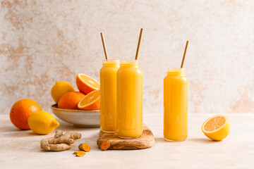 Sticker - Smoothie. Healthy fresh raw detox citrus smoothie with orange, lemon, ginger and turmeric in a glass bottles on a table. Healthy diet vegan food full of antioxidants