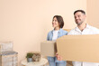 © New Africa - Happy couple with moving boxes in new apartment