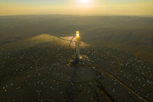 Hydroelectric Solar Tower Power Station At Sunrise In A Desert Landscape