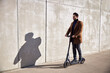 © baranq - Man commute to work on electric scooter. E-mobility concpet
