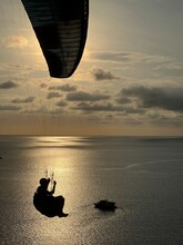 Silhouette Of A Person On A Parachute Flying In A Sky Over Andaman Sea - Dreamy Landscape View - Sunset In Phuket