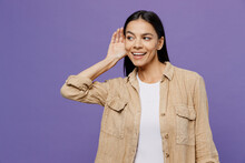 Young Curious Nosy Fun Latin Woman Wearing Light Shirt Casual Clothes Try To Hear You Overhear Listening Intently Isolated On Plain Pastel Purple Color Background Studio Portrait. Lifestyle Concept.