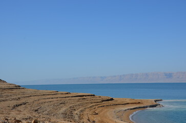 panoramic view of the beautiful, clear blue dead sea shimmering and shining on a bright sunny day in