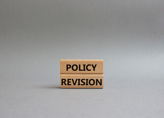 Canvas Print - Policy revision symbol. Concept word Policy revision on wooden blocks. Beautiful grey background. Business and Policy revision concept. Copy space