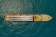 Heavy load carrier ship loaded with Electric Turbine Blades anchored at Sea, Aerial view