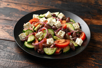 Wall Mural - Greek salad with fresh vegetables, feta cheese, kalamata olives, dried oregano, red wine vinegar and olive oil. Healthy food.