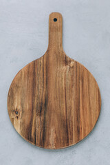 Wall Mural - Chopping board. Empty round wooden cutting board on gray stone background, top view, copy space.