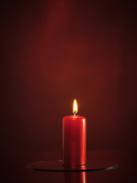 Fototapete - Red candle on a red background