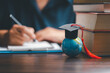 © JD8 - Graduation cap with Earth globe. Concept of global business study, abroad educational, Back to School. Education in Global world, Study abroad business in universities in worldwide. language study