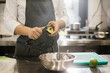© dsheremeta - The chef is preparing food. Close-up of a male chef peeling an avocado.