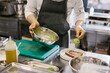 © dsheremeta - The chef is preparing food. Close-up of a male chef preparing avocado toast in a spacious modern kitchen.