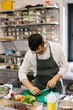 © dsheremeta - Preparing vegetables for a delicious bowl dish: a male chef in a contemporary restaurant kitchen.