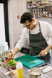 © dsheremeta - Preparing vegetables for a delicious bowl dish: a male chef in a contemporary restaurant kitchen.