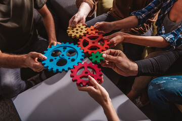 Business team connect pieces of gears. Teamwork, partnership and integration concept