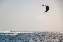 A Person Doing Kitesurfing On The Ocean