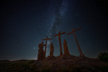 crucifixion of christ scene on top of a hill against starry night