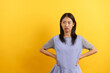 © Pichsakul - Young women angry face sitting hands on waist akimbo with empty space on isolated yellow background