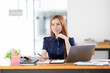© David - Asian Businesswoman Using laptop computer and working at office with calculator document on desk, doing planning analyzing the financial report, business plan investment, finance analysis concept.