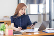 © David - Business Asian woman Accounting using Phone calculating income-expenditure and analyzing real estate investment data report Financial and tax Business systems concept.