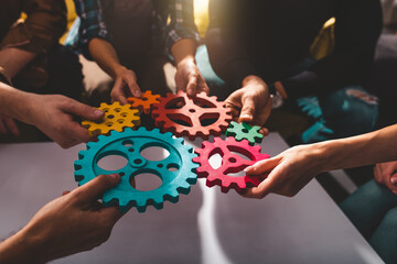 teamwork of business people work together and combine pieces of gears