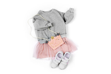 Wall Mural - Fashion kids dress with cute bag and sneakers on white background. Stylish children's clothes for spring. Trendy outfit. Flat lay, top view