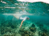 Fototapeta Łazienka - woman snorkeling in clear tropical sea