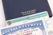 United States passport, social security card and permanent resident (green) card on white background. Immigration concept	