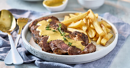 Wall Mural - sliced beef steak with sauce and french fries