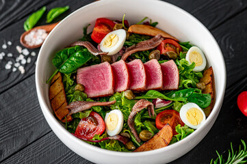 Canvas Print - Salad Nisuaz with tuna, anchovies, potatoes, cherry tomatoes, salad mix, olive oil and quail egg