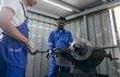 © winnievinzence - Diversity mechanic worker or metalworker using metal lathe machine operate polishing car disc brake at auto repair garage. Maintenance automotive and inspecting vehicle part concept