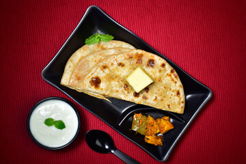 Wall Mural - Aloo paratha served with curd and pickle, stuffed butter paratha