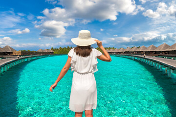 Poster - Woman standing on the wooden pier