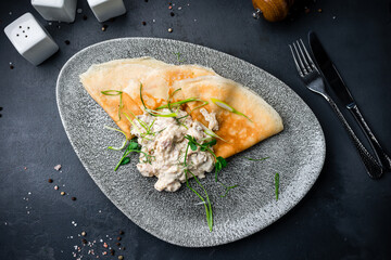 Canvas Print - Thin pancakes with meat, sauce and microgreens.