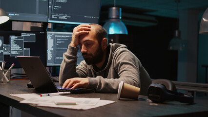 Software engineer yawning and falling asleep on desk, being exhausted and trying to work on new interface programming. Man feeling sleepy and tired late at night, using server code. Handheld shot.