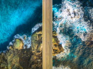 Wall Mural - aerial view of road, sea with waves and stones at sunset in lofoten islands, norway. landscape with 