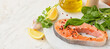 Raw salmon steak, herbs and spices on light background with space for text