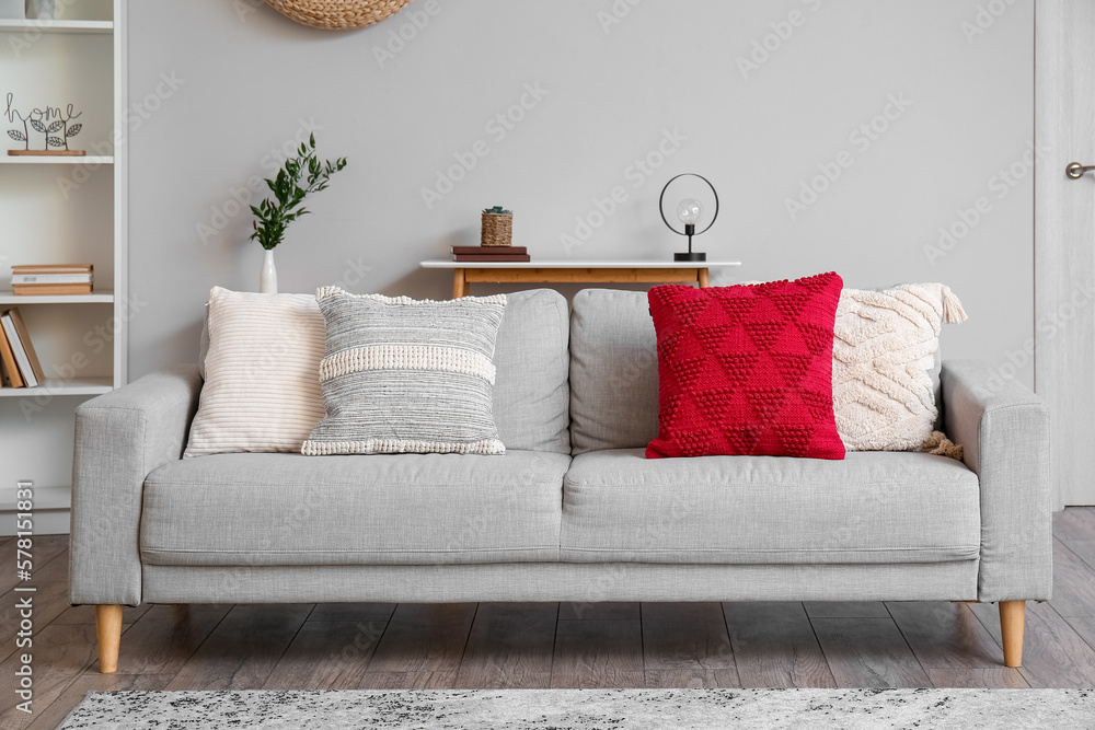 Stylish interior of living room with comfortable sofa and pillows