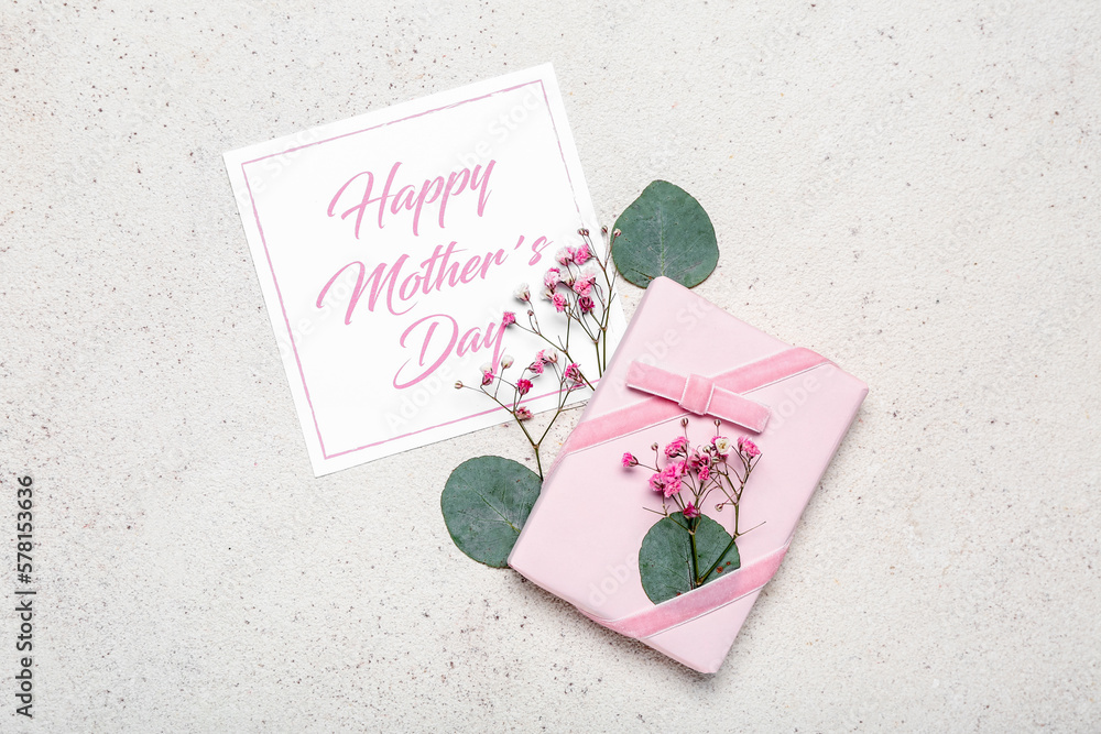 Card with text HAPPY MOTHER'S DAY and beautiful gift box on light background