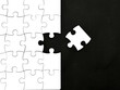 © airdone - White jigsaw puzzle on black background, top angle view