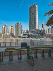 Wall Mural - Dubai Marina, harbour, cruise boat and canal promenade view at sunset, in Dubai, United Arab Emirates