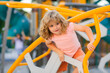 Childhood. Cute kid having fun at playground. Happy kid having fun on playground. Kid climbing on playground.