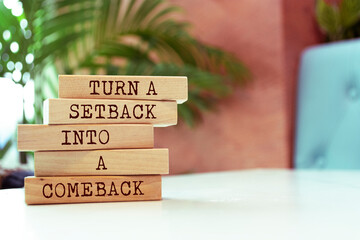 Wall Mural - Wooden blocks with words 'Turn a setback into a comeback'.