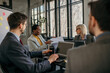 © La Famiglia - Smiling diverse female entrepreneurs talking to their colleagues about business reports of the economy grow at a meeting in the office.
