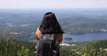 Female Hiker Looks Out Over Beautiful Summer Landscape On Top Of A Mt. Tremblant.