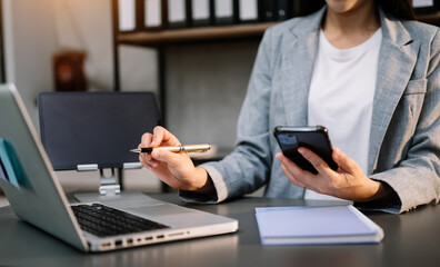 businesswoman hand using smart phone laptop and tablet with social network diagram on desk as concep