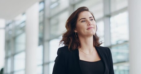 Poster - Confident, focused and powerful business woman walking down a corridor in a modern office building. Young female corporate professional going or leaving the workplace after a successful day