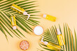 Flat lay with Natural organic cosmetics with green palm leaves on orange background. Skincare, cosmetology, dermatology concept. Beauty certificate, blog style. Top view, mockup, overhead