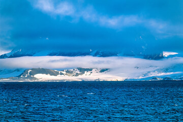 Wall Mural - View into land at a rocky coastline in Arctic