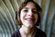 © Cavan Images - Closeup of a girl smiling with braces